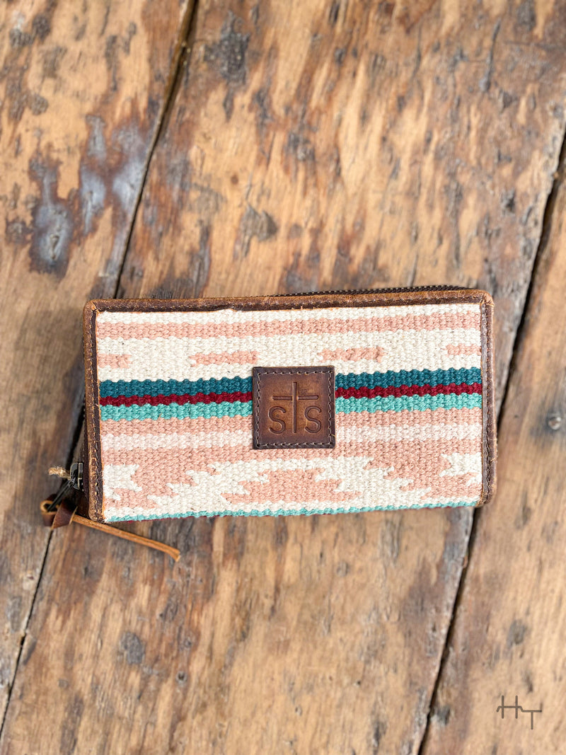 Photo of front of pastel aztec wallet with leather sts patch on front