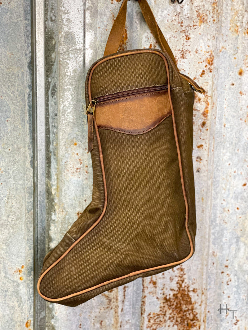Photo of back of boot bag made with brown canvas and leather accents with zipper pocket and tin background