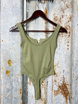Photo of back view of olive green bodysuit on hanger