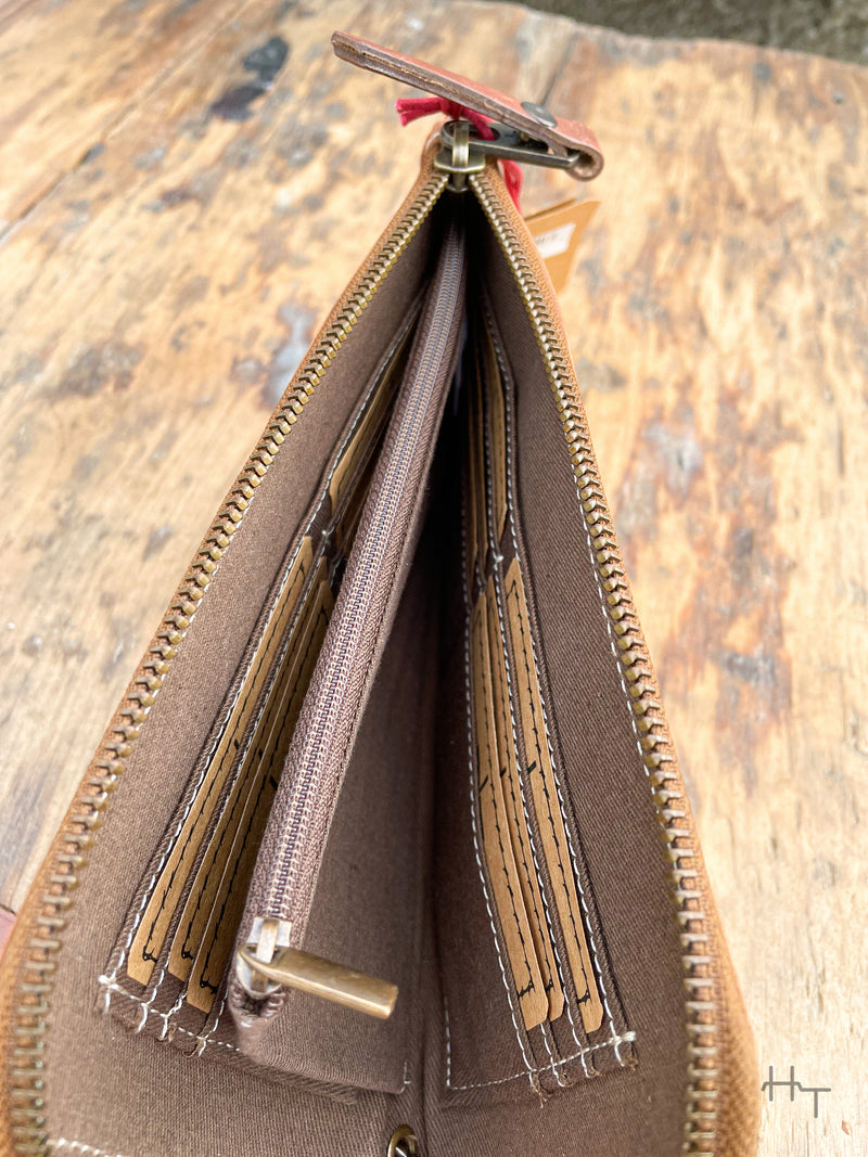 Photo of inside of clutch with fabric liner card slots and zipper divider