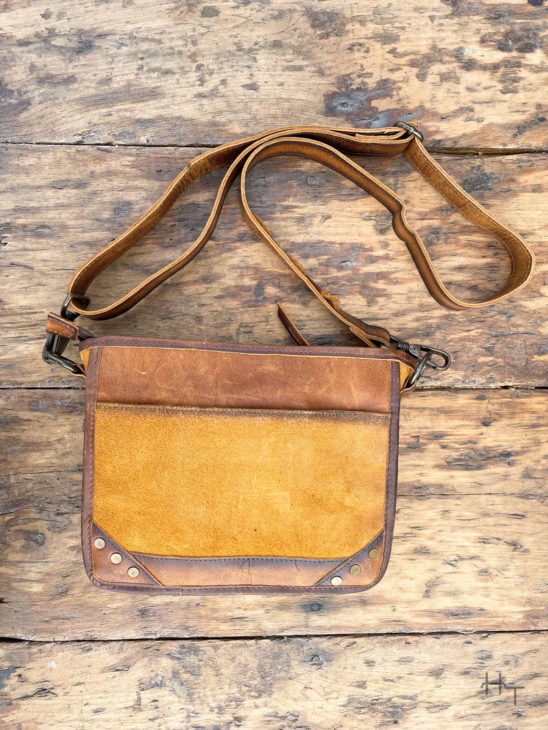 Photo of back of leather purse with slip pocket and long crossbody strap