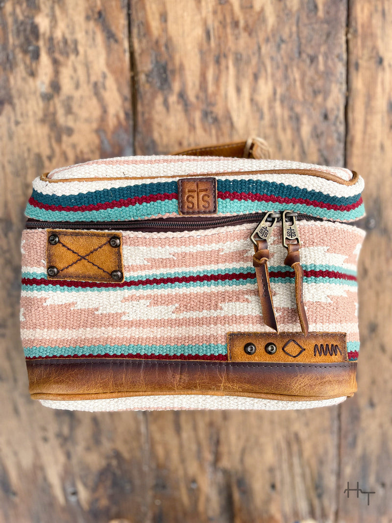 Photo of front of pastel aztec print woven cosmetic bag with leather accents 