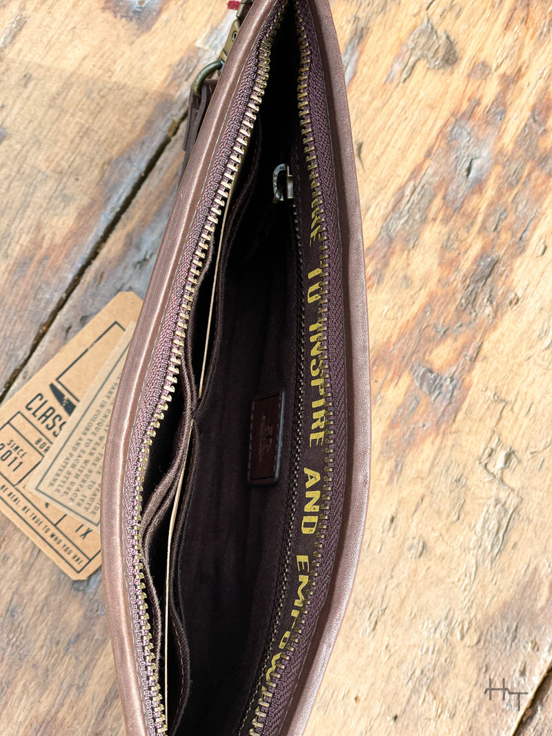 Photo of inside of dark brown wallet clutch with zipper pocket and card slots