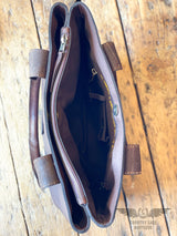 Picture of one of the 3 fabric lined compartments of the westward tote.  Image shows inside zipper pocket, conceal carry holster, and magnetic closure 
