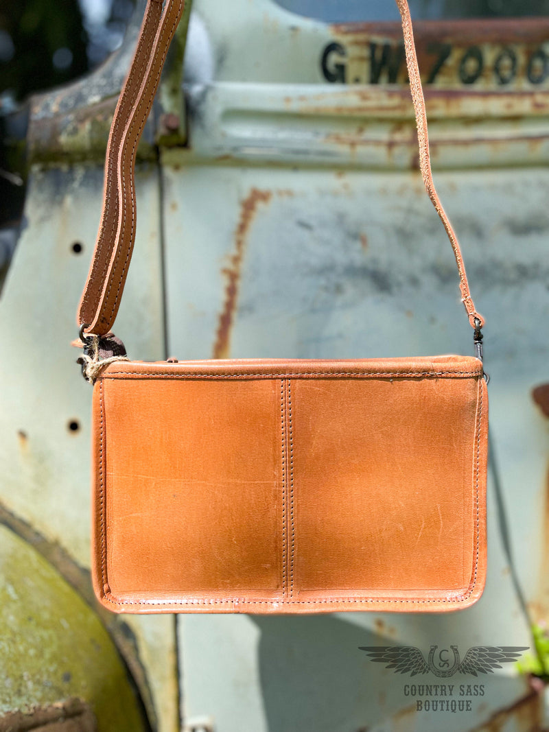 Image of the back of the Yipee Kiyay Claire crossbody purse.  Solid veggie tan leather.