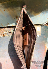 Image on the interior of the yipee kiyay clutch wallet.  Brown cloth interior with 1 bill pocket, 6 card slots, 1 zipper pocket, inspirational quote "All You Need Is Love", and Leather STS ranchwear patch.  Zipper closure.